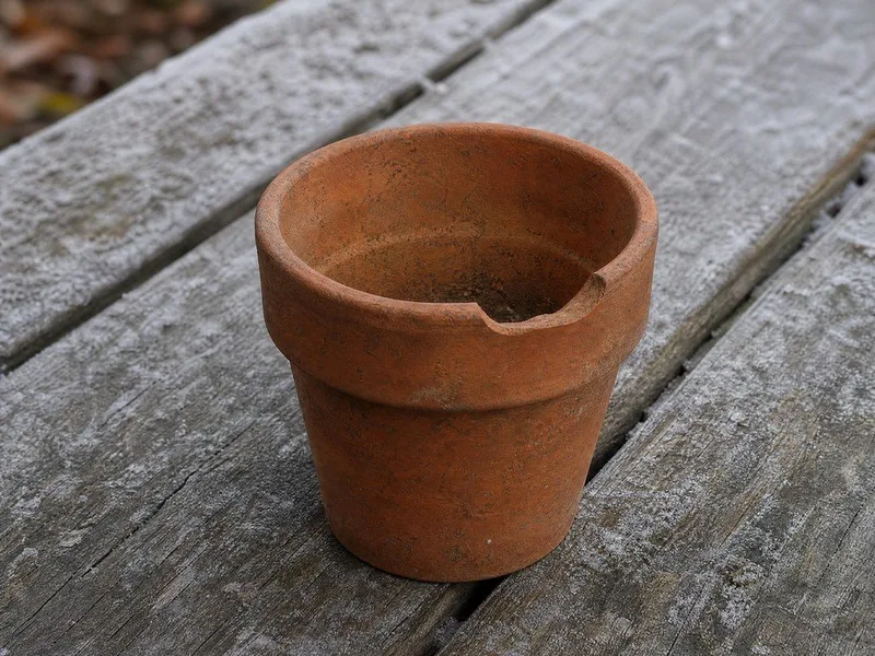 An empty terracotta pot with a chipped rim
